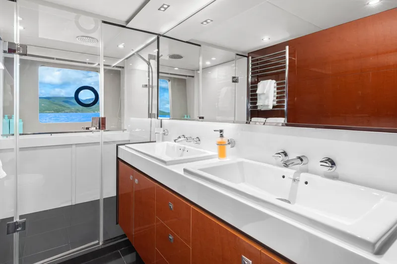 About Time Yacht Photos Pics Luxurious bathroom in 2014 Princess Flybridge 72 Motor Yacht with dual sinks and ocean view.