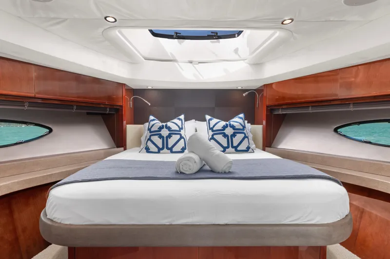About Time Yacht Photos Pics Luxurious bedroom interior of 2014 Princess Flybridge 72 Motor Yacht with skylight and elegant decor.
