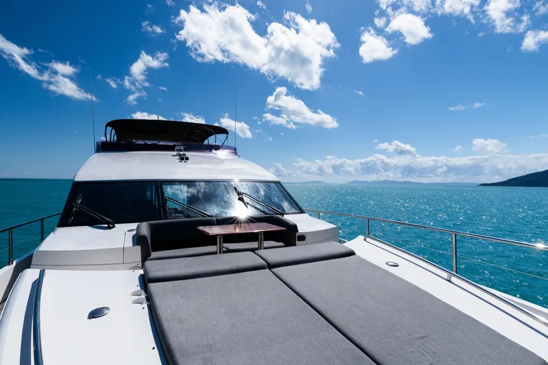 About Time Yacht Photos Pics 2014 Princess Flybridge 72 Motor Yacht on open sea under blue sky.