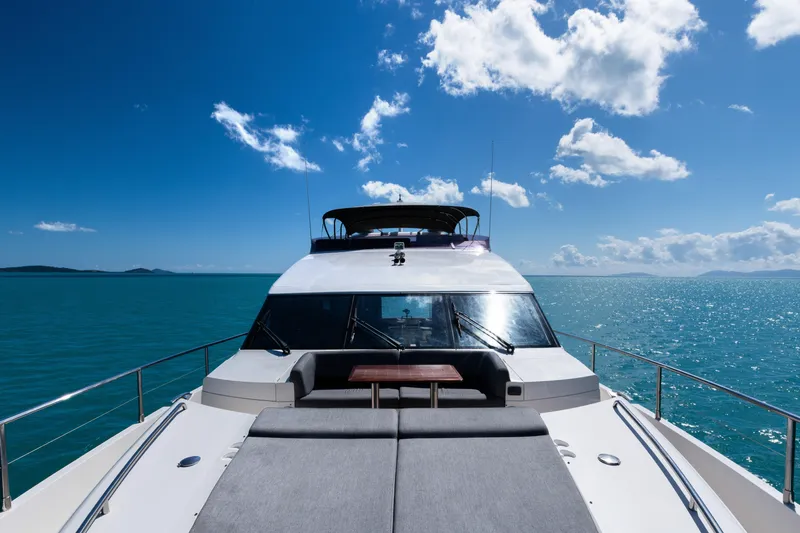 About Time Yacht Photos Pics 2014 Princess Flybridge 72 Motor Yacht cruising on a sunny day, blue ocean backdrop.