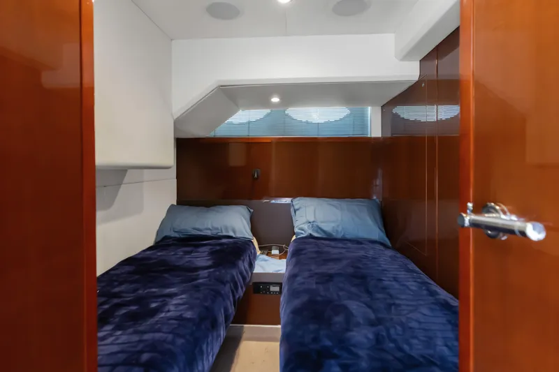 About Time Yacht Photos Pics Twin cabin with blue bedding on 2014 Princess Flybridge 72 Motor Yacht.