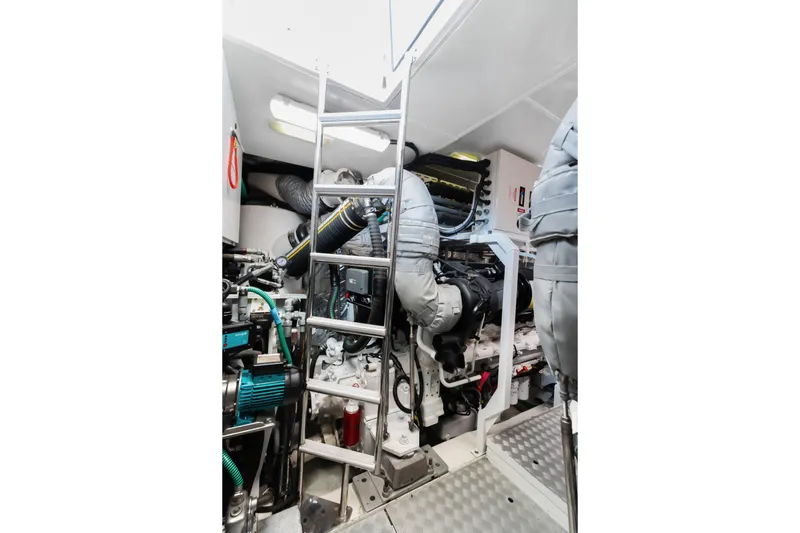 About Time Yacht Photos Pics Engine room of 2014 Princess Flybridge 72 Motor Yacht with ladder and machinery.
