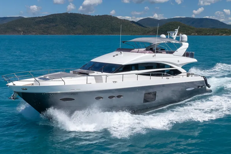 About Time Yacht Photos Pics 2014 Princess Flybridge 72 Motor Yacht cruising on blue ocean waters.