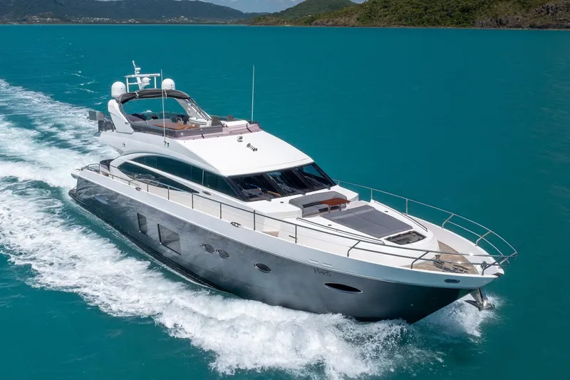 About Time Yacht Photos Pics 2014 Princess Flybridge 72 Motor Yacht cruising on turquoise waters.