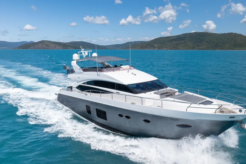 About Time Yacht Photos Pics Luxurious 2014 Princess Flybridge 72 Motor Yacht cruising on clear blue waters.