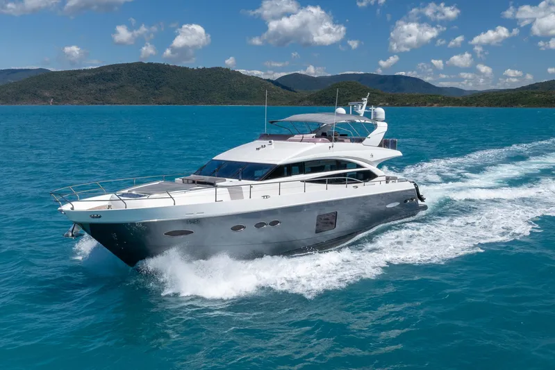 About Time Yacht Photos Pics 2014 Princess Flybridge 72 Motor Yacht cruising on turquoise waters.