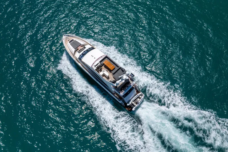 About Time Yacht Photos Pics Aerial view of 2014 Princess Flybridge 72 Motor Yacht cruising on blue ocean waters.