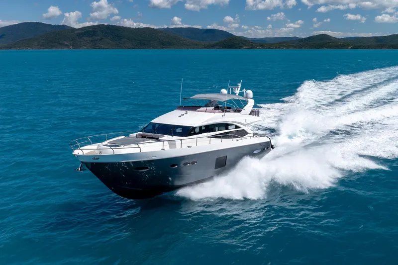 About Time Yacht Photos Pics 2014 Princess Flybridge 72 Motor Yacht cruising on blue ocean waters.