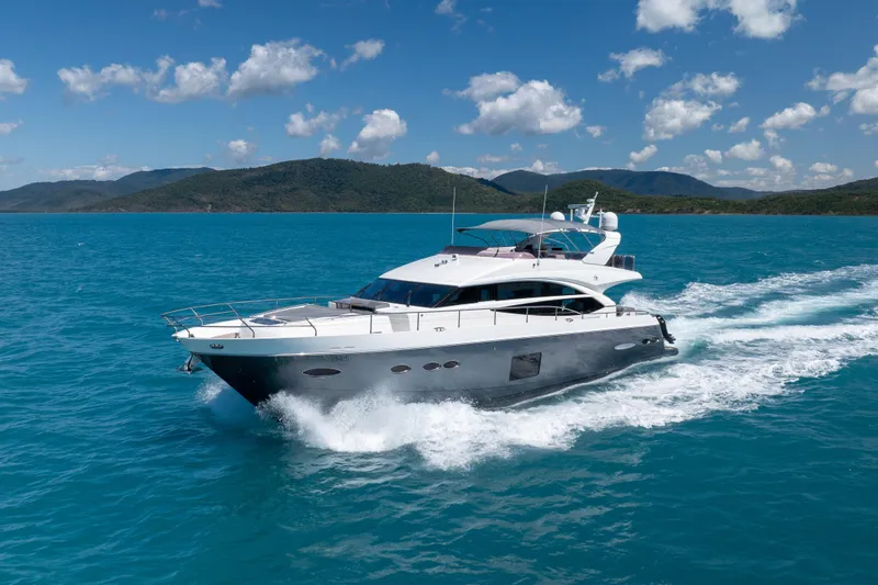 About Time Yacht Photos Pics 2014 Princess Flybridge 72 Motor Yacht cruising on clear blue waters.