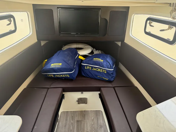  Yacht Photos Pics Interior of 2020 Scout 355 LXF boat with life jackets and TV.