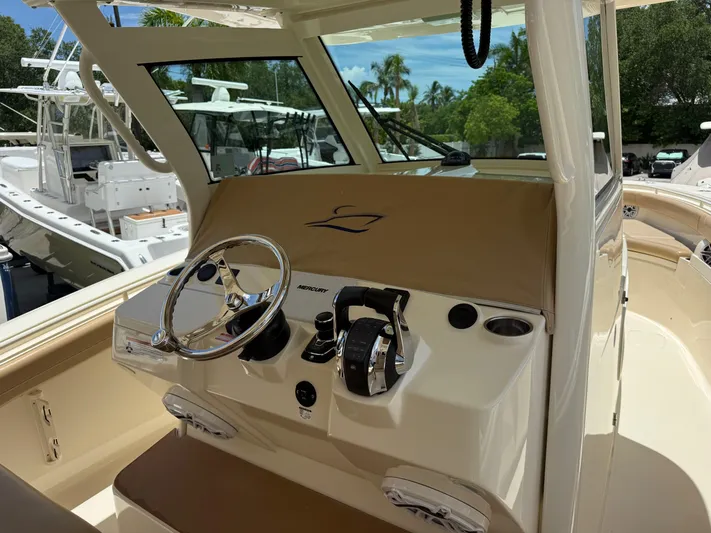  Yacht Photos Pics 2020 Scout 355 LXF boat helm with steering wheel and controls.