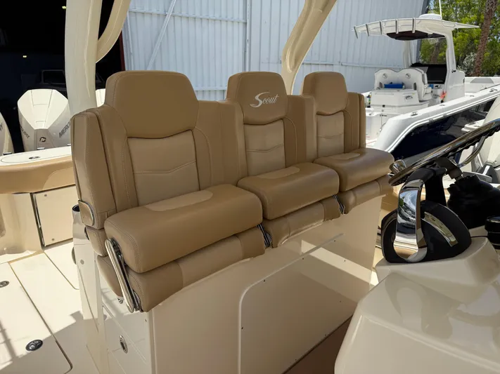  Yacht Photos Pics 2020 Scout 355 LXF boat with tan leather seating and modern helm controls.