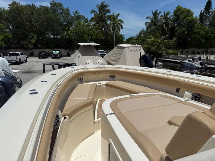  Yacht Photos Pics 2020 Scout 355 LXF boat with tan seating, docked near palm trees.