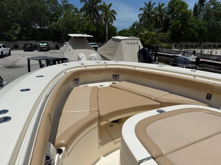  Yacht Photos Pics 2020 Scout 355 LXF boat with tan seating, docked near palm trees.