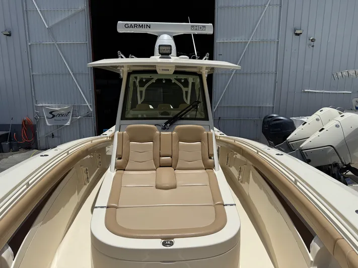  Yacht Photos Pics 2020 Scout 355 LXF boat with tan seating and Garmin equipment in a marina setting.