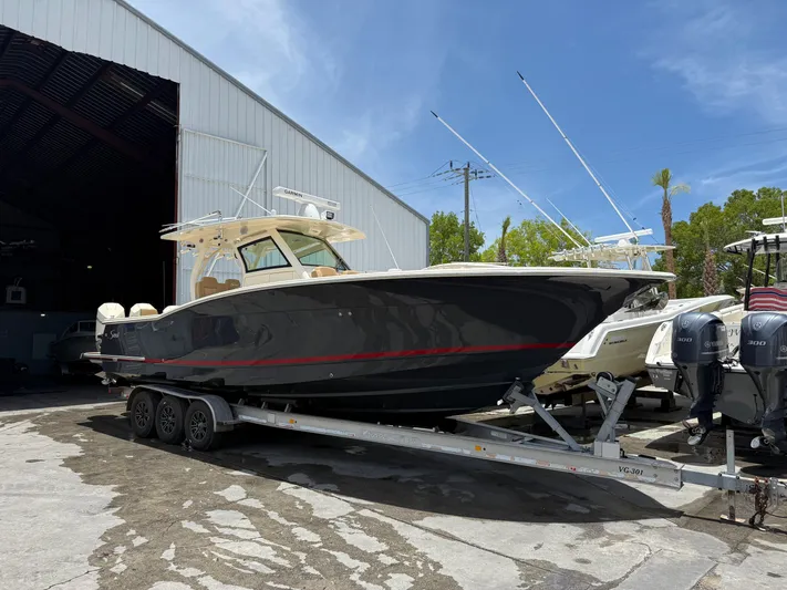 Yacht Photos Pics 2020 Scout 355 LXF boat on trailer outside storage facility.