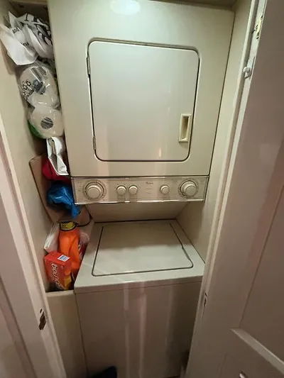  Yacht Photos Pics Compact laundry area on 1969 Hatteras 45 Sportfish boat with stacked washer and dryer.