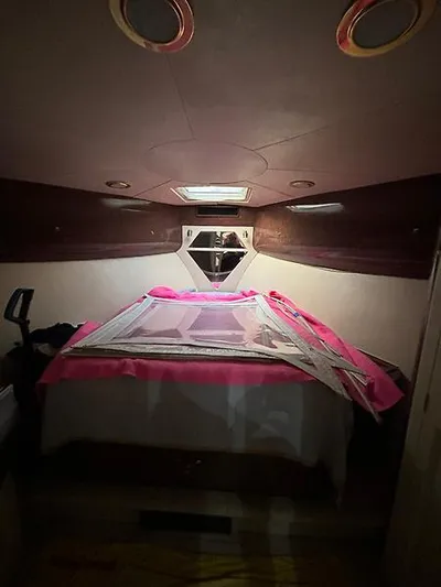  Yacht Photos Pics Interior cabin of 1969 Hatteras 45 Sportfish with bed and pink cover.