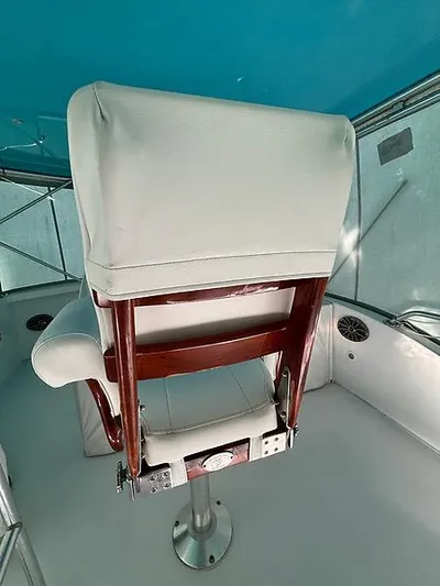  Yacht Photos Pics Captain's chair on 1969 Hatteras 45 Sportfish boat, featuring white upholstery and wooden frame.