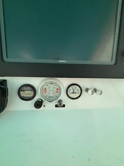  Yacht Photos Pics Dashboard of a 1969 Hatteras 45 Sportfish boat with gauges and controls.
