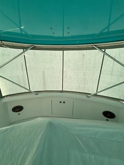  Yacht Photos Pics 1969 Hatteras 45 Sportfish boat interior with teal ceiling and covered seating area.