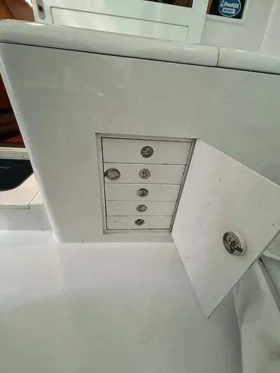  Yacht Photos Pics 1969 Hatteras 45 Sportfish boat storage compartment with open door and drawers.