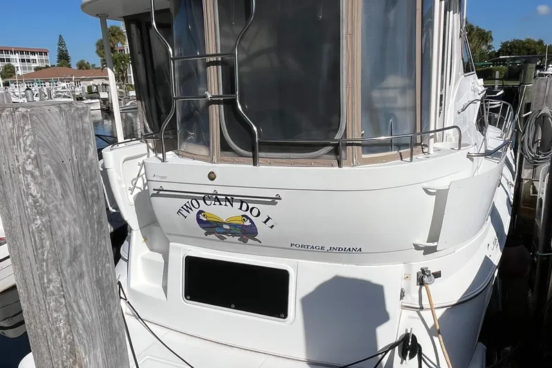 Two Can Do It Yacht Photos Pics Cruisers Yachts 4450, 2000 model, docked with "Two Can Do It" nameplate.