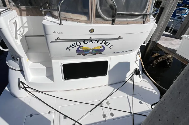 Two Can Do It Yacht Photos Pics Cruisers Yachts 4450, 2000 model, docked with "Two Can Do It" name on stern.