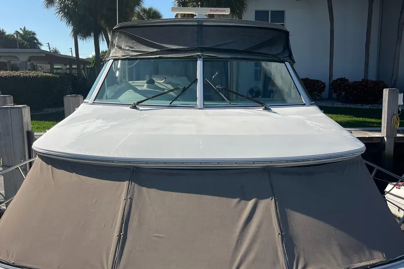 Two Can Do It Yacht Photos Pics Front view of a 2000 Cruisers Yachts 4450 docked, featuring a covered deck.