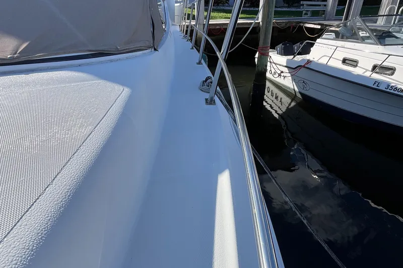 Two Can Do It Yacht Photos Pics Cruisers Yachts 4450, 2000 model, docked beside another boat.