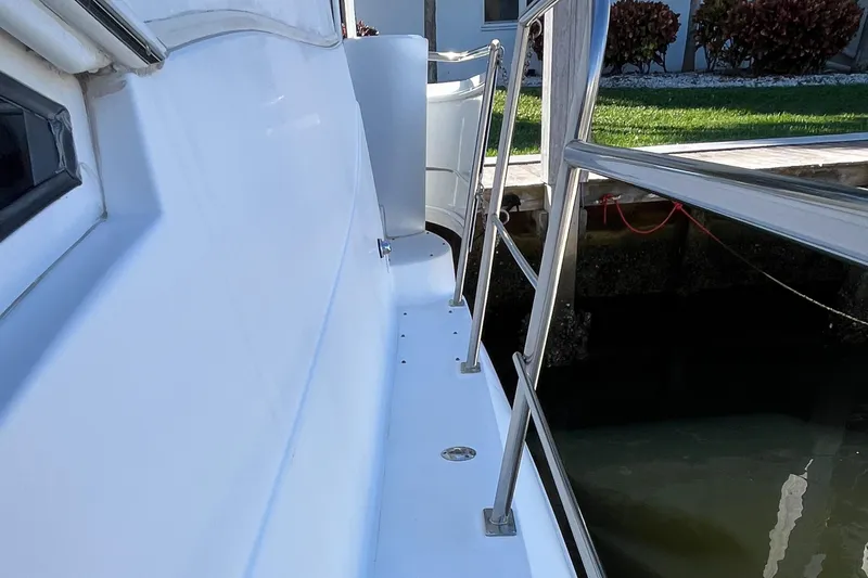 Two Can Do It Yacht Photos Pics 2000 Cruisers Yachts 4450 side deck with railing, docked near water.