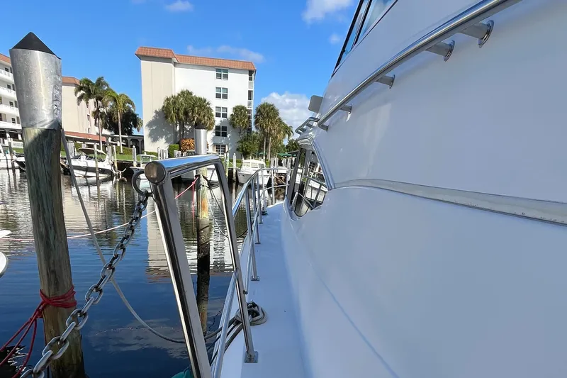 Two Can Do It Yacht Photos Pics Cruisers Yachts 4450, 2000 model, docked at marina with clear blue sky.
