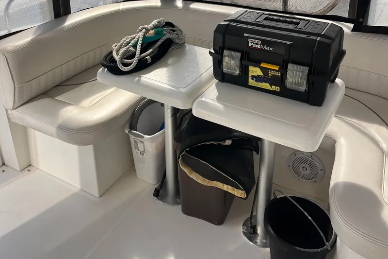 Two Can Do It Yacht Photos Pics Interior of 2000 Cruisers Yachts 4450 with seating, tables, toolbox, and rope.