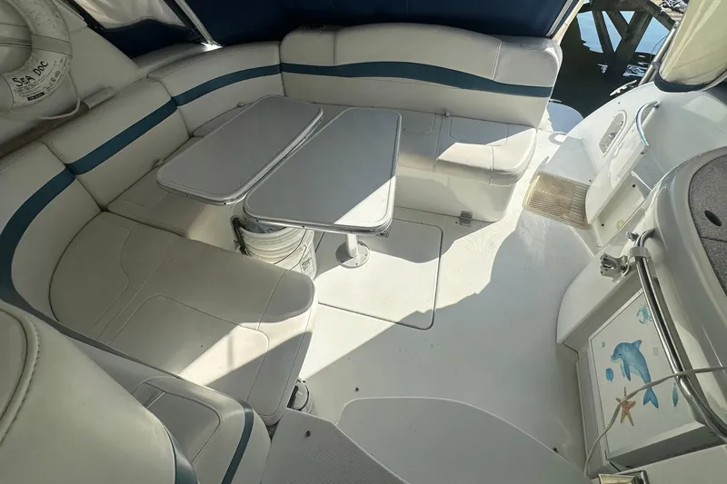 Sea Doc III Yacht Photos Pics 2005 Formula 37 PC boat interior with white seating and foldable table.
