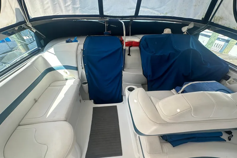 Sea Doc III Yacht Photos Pics 2005 Formula 37 PC boat interior with white seating and blue covers.