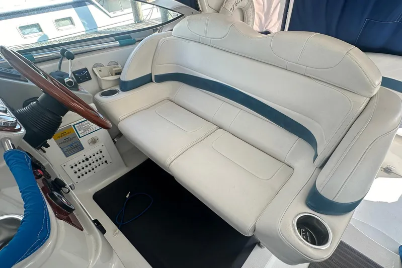 Sea Doc III Yacht Photos Pics 2005 Formula 37 PC boat interior with white and blue seating, steering wheel, and controls.