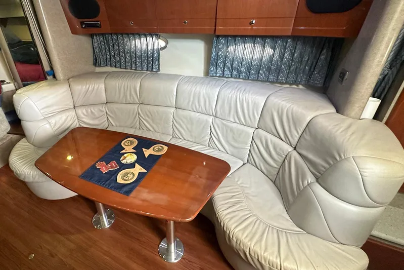 Sea Doc III Yacht Photos Pics Luxurious interior of a 2005 Formula 37 PC yacht with leather seating and wooden table.