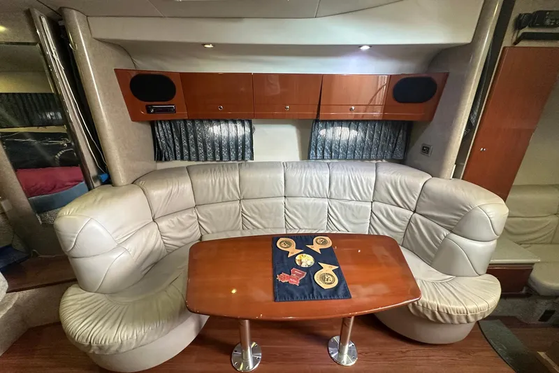 Sea Doc III Yacht Photos Pics Luxurious interior of 2005 Formula 37 PC yacht with leather seating and wooden table.