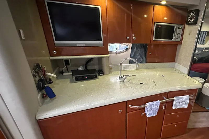 Sea Doc III Yacht Photos Pics 2005 Formula 37 PC yacht kitchen with TV, microwave, and sleek countertops.