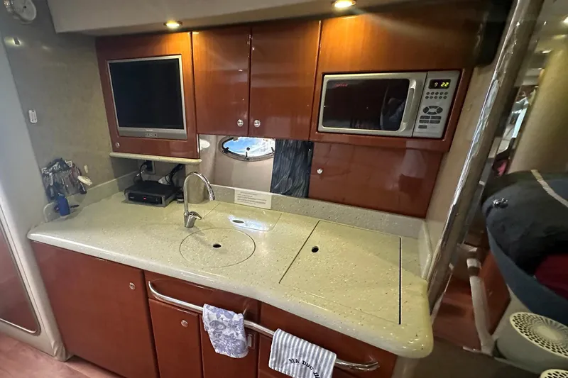 Sea Doc III Yacht Photos Pics 2005 Formula 37 PC yacht kitchen with microwave, sink, and TV.