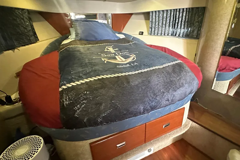 Sea Doc III Yacht Photos Pics Cozy cabin interior of 2005 Formula 37 PC boat with nautical-themed bedding.