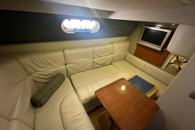 Sea Doc III Yacht Photos Pics Interior of 2005 Formula 37 PC yacht with leather seating and wooden table.