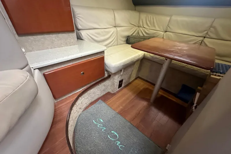 Sea Doc III Yacht Photos Pics 2005 Formula 37 PC yacht interior with cozy seating and wooden table.