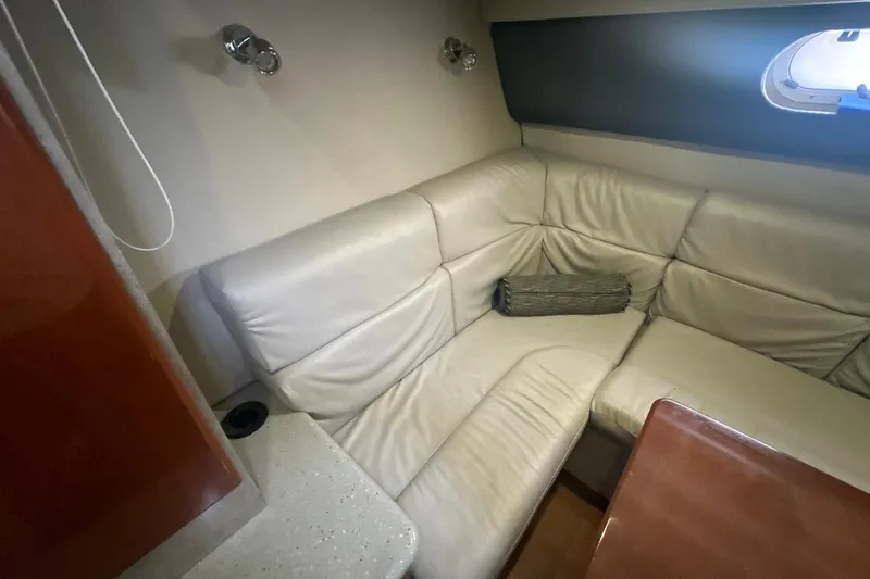 Sea Doc III Yacht Photos Pics Luxurious leather seating in 2005 Formula 37 PC yacht interior with window and table.