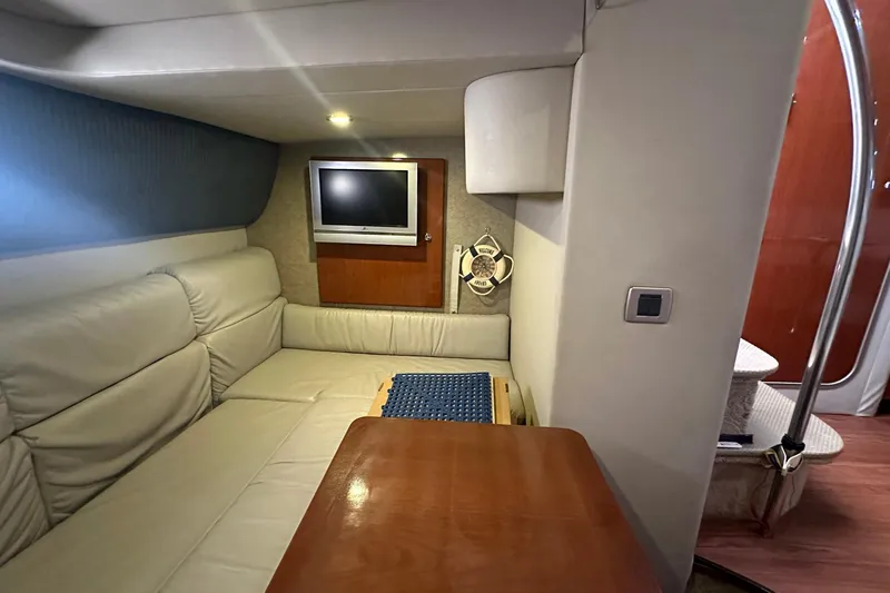 Sea Doc III Yacht Photos Pics 2005 Formula 37 PC yacht interior with leather seating, TV, and wooden table.