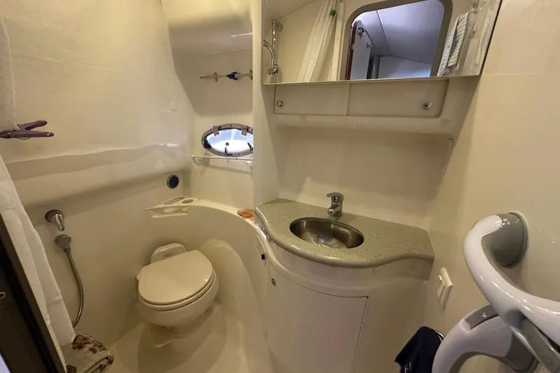 Sea Doc III Yacht Photos Pics 2005 Formula 37 PC yacht bathroom with sink, toilet, and porthole window.