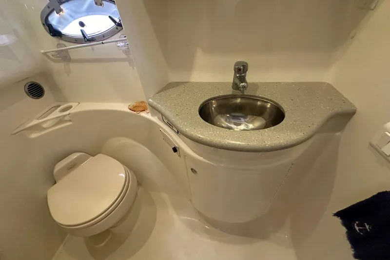 Sea Doc III Yacht Photos Pics Compact bathroom in a 2005 Formula 37 PC yacht with sink and toilet.