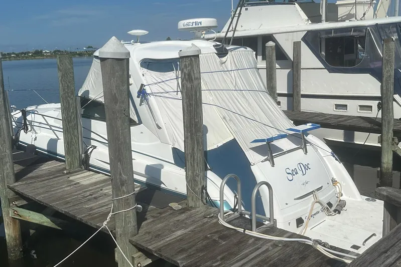 Sea Doc III Yacht Photos Pics 2005 Formula 37 PC boat docked, covered, with "Sea Doc" on the stern.