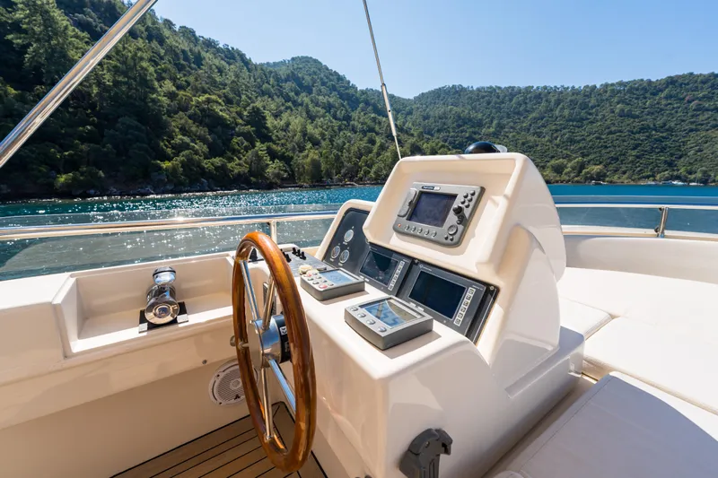 Jasmine 3 Yacht Photos Pics 2011 Apreamare Maestro 65 yacht helm with scenic water and forest backdrop.