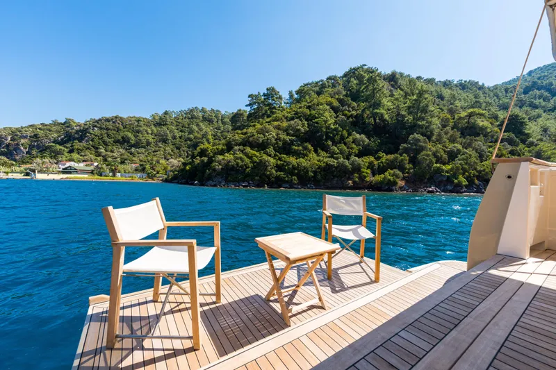 Jasmine 3 Yacht Photos Pics Deck of 2011 Apreamare Maestro 65 yacht with chairs, table, and scenic view.